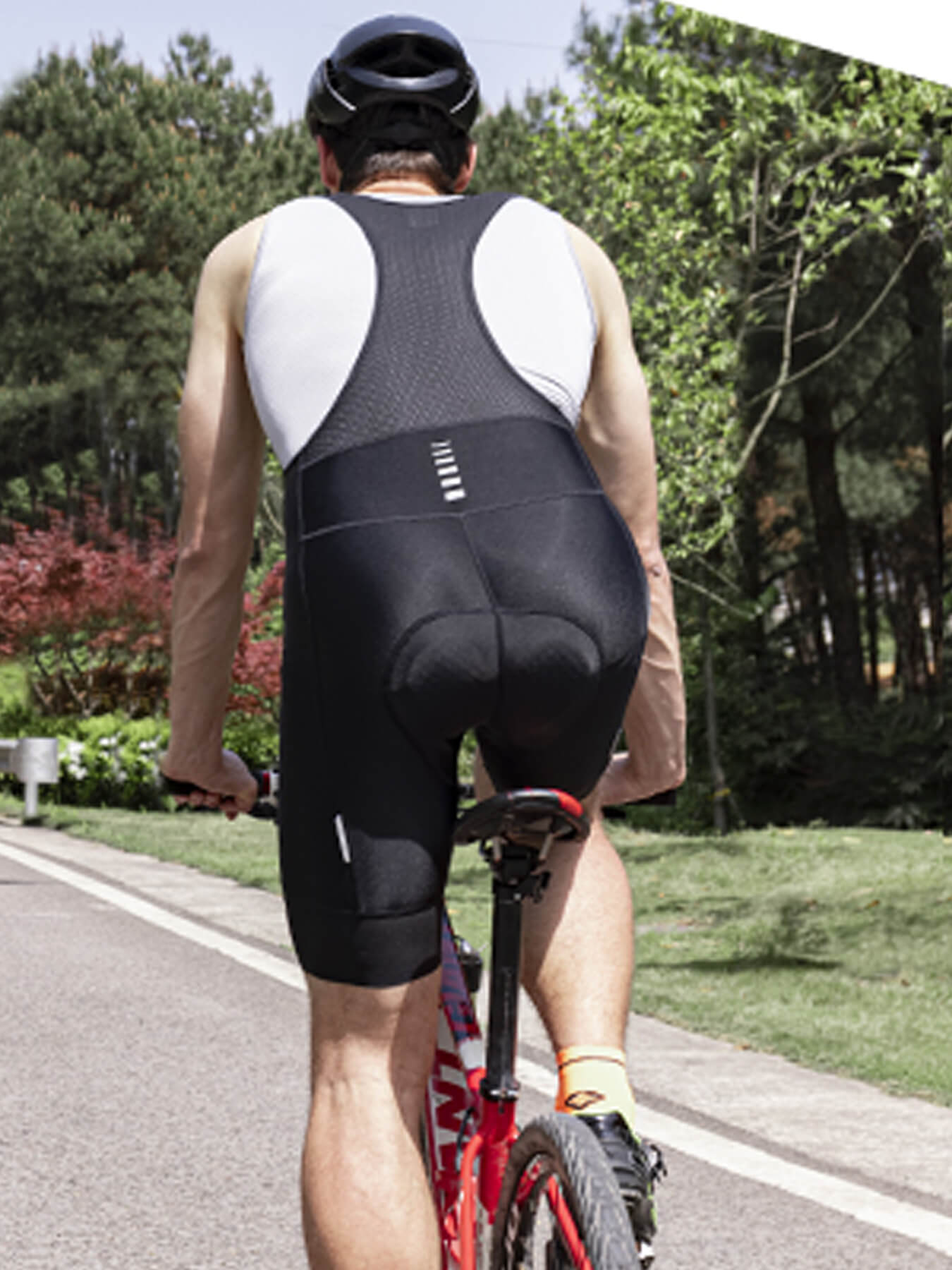 Back view of black cycling bib shorts with padded seat and leg panels