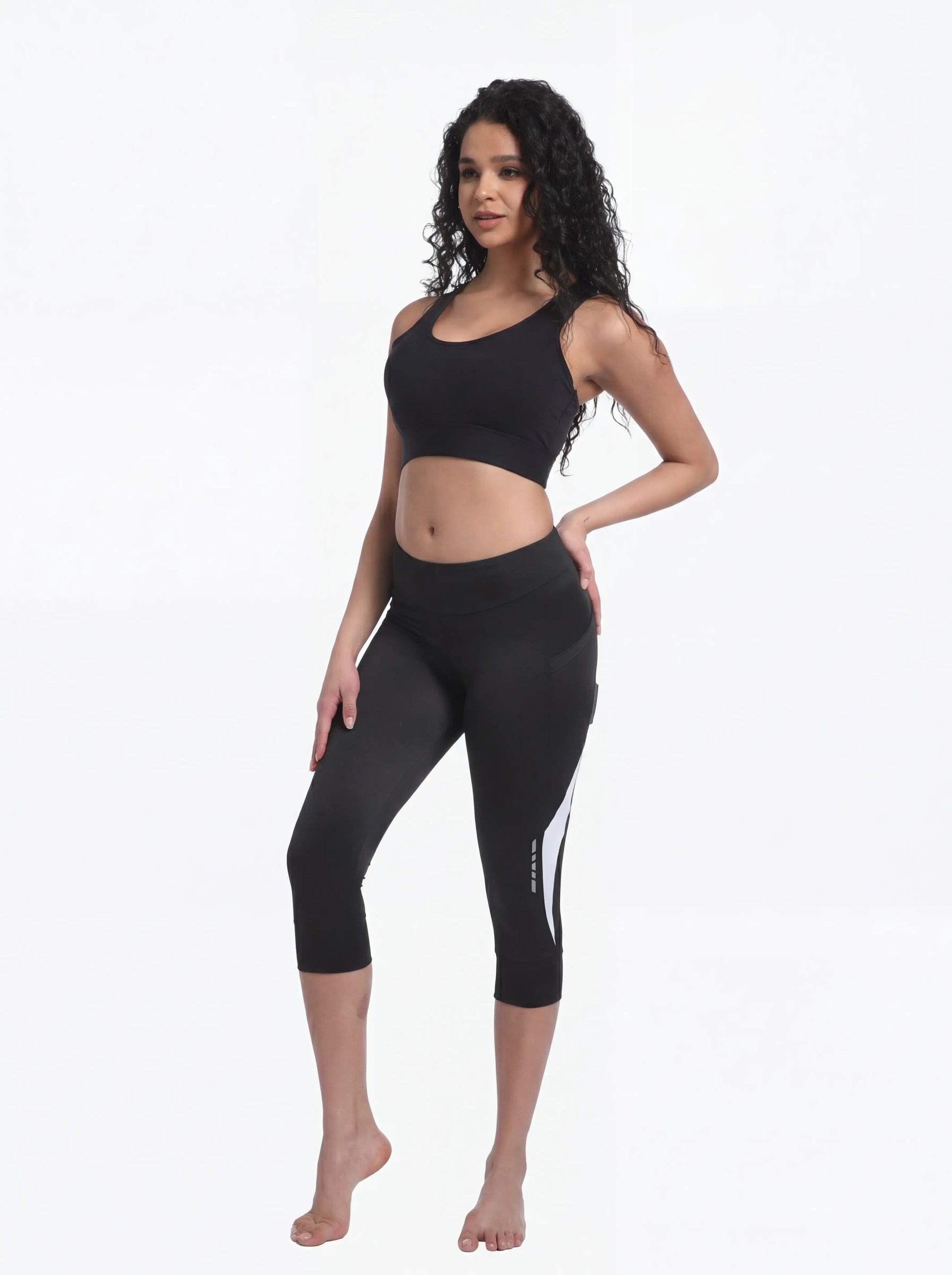 QUALICOS Women's Cycling Capri Pants with Pockets angled front view, 3/4 length fit and reflective leg details